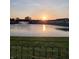 Scenic community pond view featuring a fountain and beautiful sunset reflecting on the water at 230 Kiawah Dr, Whiteland, IN 46184