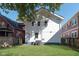 White siding on home exterior with large backyard and mature tree at 2442 Guilford Ave, Indianapolis, IN 46205