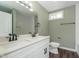 Contemporary bathroom featuring double sinks, white cabinets, and a tiled shower at 2442 Guilford Ave, Indianapolis, IN 46205