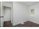 Bright bedroom featuring wood-look floors, closet, and a sunlit window at 2442 Guilford Ave, Indianapolis, IN 46205