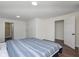 Simple bedroom with wood-look floors, ensuite bathroom, closet, and blue and white comforter at 2442 Guilford Ave, Indianapolis, IN 46205