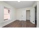 Empty room with dark wood-look floors, neutral colored walls and a bright sunny window at 2442 Guilford Ave, Indianapolis, IN 46205