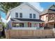 Charming two-story home with a well-maintained front yard and a classic white exterior at 2442 Guilford Ave, Indianapolis, IN 46205