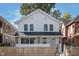 Charming two-story home with a well-maintained front yard and a classic white exterior at 2442 Guilford Ave, Indianapolis, IN 46205