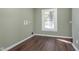 Well-lit laundry room features wood-look flooring and hookups for laundry machines at 2442 Guilford Ave, Indianapolis, IN 46205