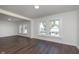 Spacious living room with wood-look floors, neutral colored walls, and many bright windows at 2442 Guilford Ave, Indianapolis, IN 46205