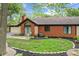 Backyard view of a brick home with a manicured lawn and charming patio at 2922 Amherst St, Indianapolis, IN 46268