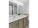 Bright bathroom featuring a double vanity with framed mirrors, and olive-green cabinets at 2922 Amherst St, Indianapolis, IN 46268