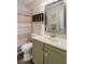 Bathroom featuring a shower with a patterned curtain, plus an olive-green vanity and toilet at 2922 Amherst St, Indianapolis, IN 46268