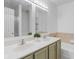 Bathroom with double sinks, framed mirrors, and olive-green vanity, plus a tub and shower at 2922 Amherst St, Indianapolis, IN 46268