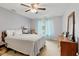 Bright bedroom with a ceiling fan, large window with curtains, light walls, and comfortable furnishings at 2922 Amherst St, Indianapolis, IN 46268