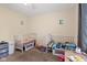 Bedroom featuring two white cribs, decorations on the wall, plus toys and books at 2922 Amherst St, Indianapolis, IN 46268