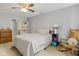Neutral bedroom with a ceiling fan, white walls, and a comfortable bed, with a bedside table and rocking chair at 2922 Amherst St, Indianapolis, IN 46268