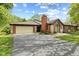 Brick home with a two-car garage, large driveway, and well-maintained landscaping at 2922 Amherst St, Indianapolis, IN 46268