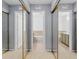 Hallway with mirrored closet doors, showcasing access to the bathroom and other rooms at 2922 Amherst St, Indianapolis, IN 46268