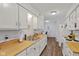 Bright kitchen features white cabinets, wood counters, and stainless-steel sink at 2922 Amherst St, Indianapolis, IN 46268