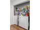 Efficient laundry area with stacked washer and dryer and ample storage shelving for laundry essentials at 2922 Amherst St, Indianapolis, IN 46268
