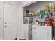 Functional laundry area with stacked washer and dryer, storage shelving, and a bright, efficient design at 2922 Amherst St, Indianapolis, IN 46268