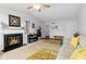 Bright living room features a fireplace, carpet flooring, and neutral decor at 2922 Amherst St, Indianapolis, IN 46268