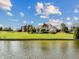 Waterfront homes feature expansive lawns extending to the water's edge, perfect for outdoor enjoyment at 3107 Waterfront Cir, Anderson, IN 46012
