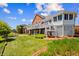 Expansive backyard with lush green lawn, lovely landscaping, and a charming brick home with large deck at 3107 Waterfront Cir, Anderson, IN 46012
