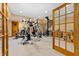 Spacious basement gym with a variety of exercise equipment and a spiral staircase at 3107 Waterfront Cir, Anderson, IN 46012