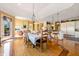 Bright dining area open to the kitchen features hardwood floors and stylish chandelier at 3107 Waterfront Cir, Anderson, IN 46012