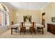 Bright dining area featuring a crystal chandelier, large window, and space for hosting, creating an elegant atmosphere at 3107 Waterfront Cir, Anderson, IN 46012