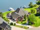 Lakeside home featuring manicured landscaping, an attached garage, and a scenic lake view at 3107 Waterfront Cir, Anderson, IN 46012