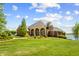 Beautiful home featuring a manicured lawn near a lake at 3107 Waterfront Cir, Anderson, IN 46012