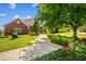 Lush green lawn with walkway leading to a brick home at 3107 Waterfront Cir, Anderson, IN 46012