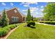 Landscaped lawn including a trimmed bush and sculpted tree at 3107 Waterfront Cir, Anderson, IN 46012