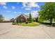 Brick home featuring a pristine lawn and an expansive circular driveway at 3107 Waterfront Cir, Anderson, IN 46012