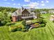 Sprawling estate featuring a manicured lawn, tiered garden, and outdoor fountain at 3107 Waterfront Cir, Anderson, IN 46012