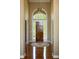 Inviting foyer with hardwood floors, arched window over the door, and elegant light fixture creating a warm entrance at 3107 Waterfront Cir, Anderson, IN 46012