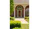 An arched front door with white pillars and green shrubbery at 3107 Waterfront Cir, Anderson, IN 46012