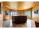 Relaxing hot tub room with wood paneled walls, tiled floor, and many windows offering natural light and scenic views at 3107 Waterfront Cir, Anderson, IN 46012