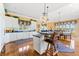Bright and airy kitchen with an island, breakfast bar, and views to dining area at 3107 Waterfront Cir, Anderson, IN 46012