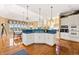 Well-designed kitchen with an island, white cabinets, and an open layout to the dining room at 3107 Waterfront Cir, Anderson, IN 46012