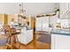 Open kitchen with a breakfast bar, stainless steel appliances, and views into the living spaces at 3107 Waterfront Cir, Anderson, IN 46012