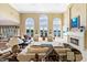 Expansive living room with high ceilings, a fireplace, and stunning lake views through expansive windows for peaceful living at 3107 Waterfront Cir, Anderson, IN 46012