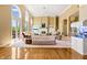 Spacious living room with wood floors, fireplace, comfortable seating, and large arched windows at 3107 Waterfront Cir, Anderson, IN 46012