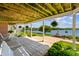 Covered patio offers a tranquil view of the lake, complemented by well-manicured landscaping at 3107 Waterfront Cir, Anderson, IN 46012