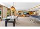 Large recreation room includes an air hockey table, ping pong table, and cozy seating area with a fireplace at 3107 Waterfront Cir, Anderson, IN 46012