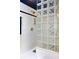 Modern tiled shower featuring a glass block wall and gold hardware at 3107 Waterfront Cir, Anderson, IN 46012