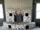 Close up of the stone fireplace, with black accent features, in the living room at 3209 Mounds Rd, Anderson, IN 46016