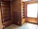 Cozy office featuring built-in bookshelves and wood paneling at 3209 Mounds Rd, Anderson, IN 46016