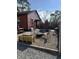 A backyard seating area with a fire pit on a rock garden with chairs and grill for outdoor enjoyment at 3302 N Gladstone Ave, Indianapolis, IN 46218