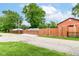 A wide driveway with a gated fence, and green trees in the background at 3302 N Gladstone Ave, Indianapolis, IN 46218