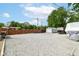 A wide driveway leads to a large backyard with a storage shed and trailer at 3302 N Gladstone Ave, Indianapolis, IN 46218